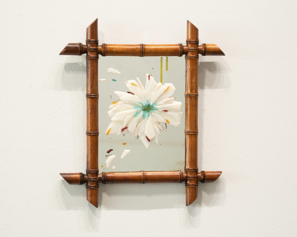 White fused glass flowers on a vintage mirror with bamboo style frame